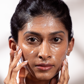 Cleansing Balm applied on model face.