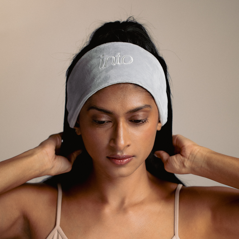 Model with headband to protect the hair from getting wet while doing skincare or washing face.