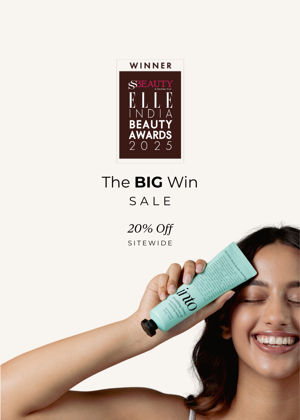 Woman holding a skincare product with 'Winner  Elle India Beauty Awards 2025' text on a white background